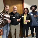 Alumni, staff and current athletic training students at a reception celebrating 20 years of accreditation for the NWU athletic program. 